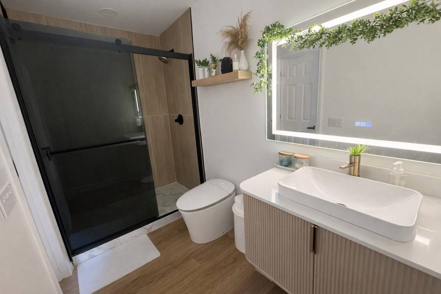 Renovated primary bathroom with LED mirror, fluted vanity, and walk-in shower, High Country NC